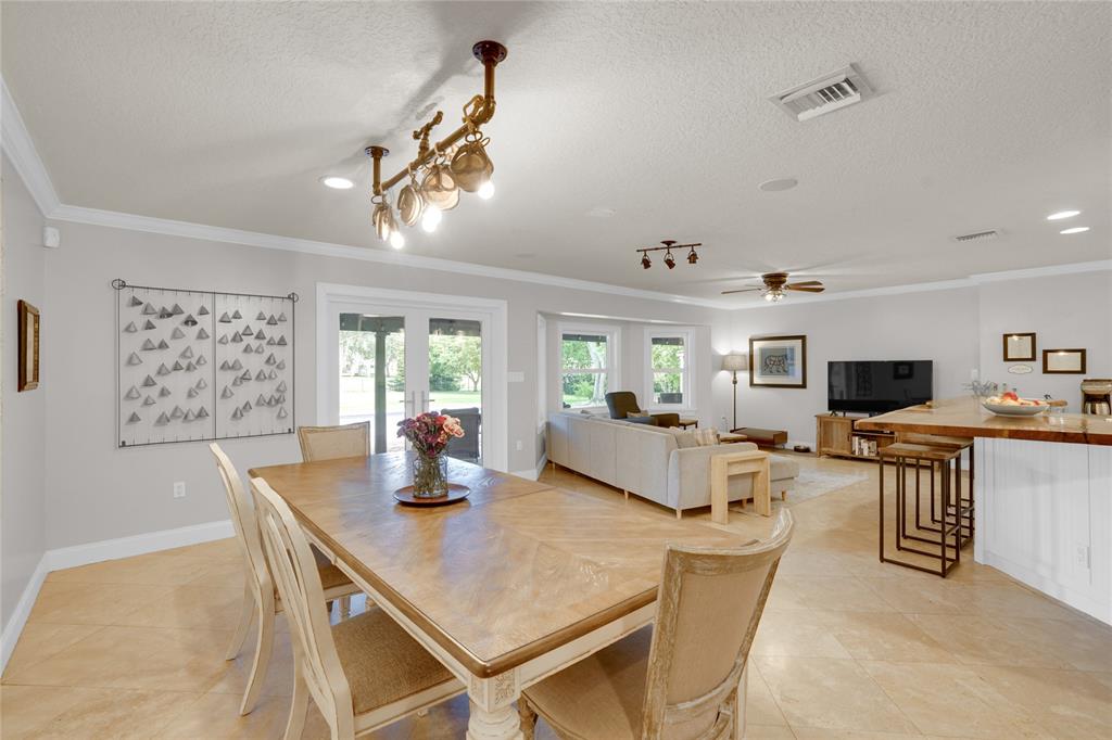 Southwest Ranches Southwest Ranches, FL 33331 - Photo 11 of 50 a living room with furniture a flat screen tv and a table