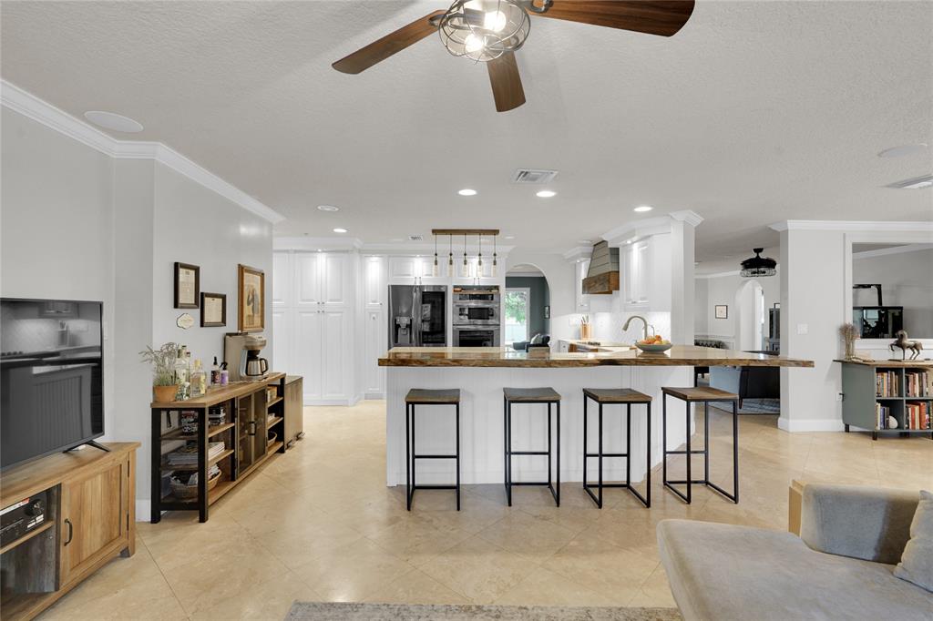 Southwest Ranches Southwest Ranches, FL 33331 - Photo 13 of 50 a kitchen with stainless steel appliances kitchen island granite countertop a table and chairs in it