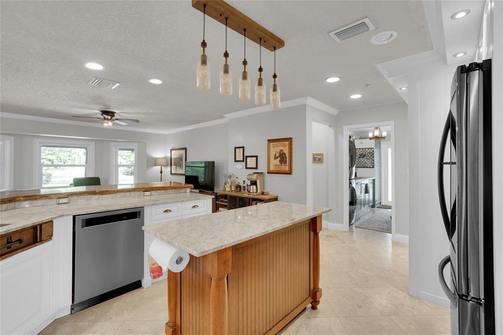 Southwest Ranches Southwest Ranches, FL 33331 - Photo 16 of 50 a kitchen with stainless steel appliances granite countertop a refrigerator a sink dishwasher a stove and white cabinets with wooden floor
