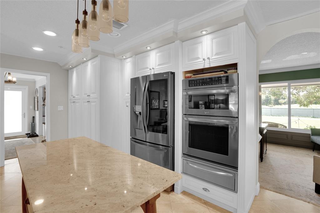 Southwest Ranches Southwest Ranches, FL 33331 - Photo 17 of 50 a kitchen with stainless steel appliances a stove a refrigerator and a sink