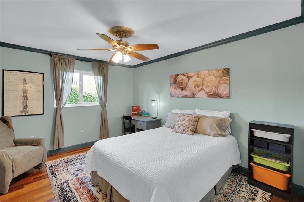 Southwest Ranches Southwest Ranches, FL 33331 - Photo 30 of 50 a bedroom with a bed and a chandelier