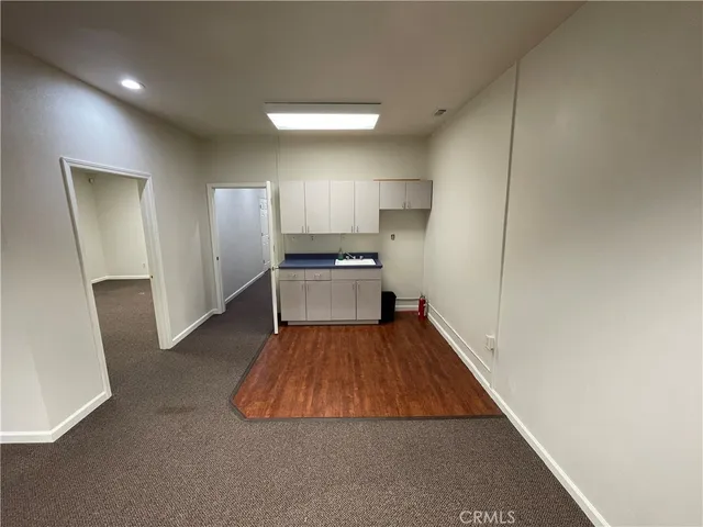 a kitchen with kitchen island white cabinets and stainless steel appliances