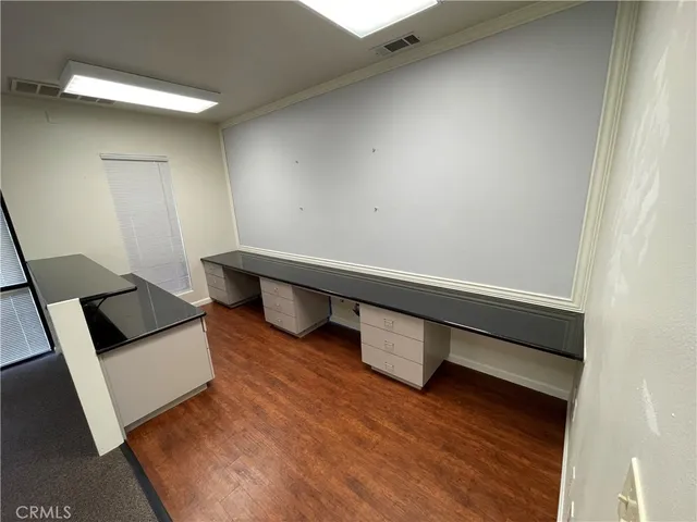 an empty room with a projector space and windows