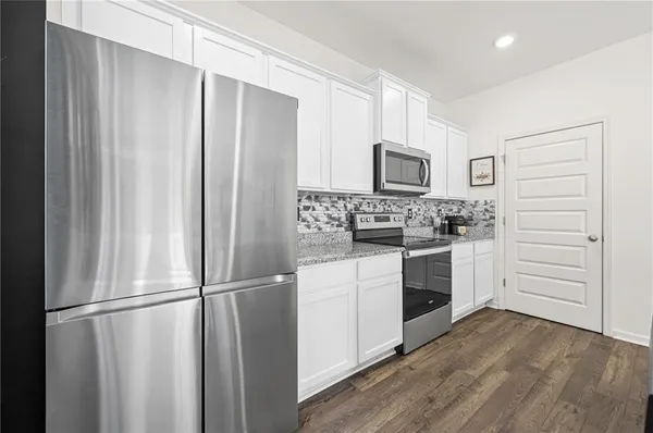 a kitchen with a refrigerator stove and microwave