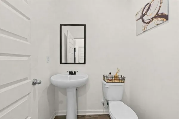 a bathroom with a toilet sink and mirror