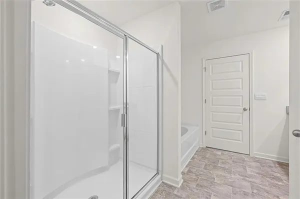 a spacious bedroom with a bed and a large window