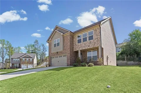 a front view of house with yard and garage