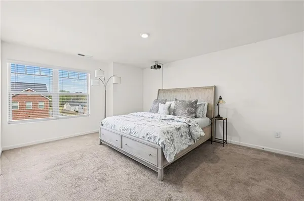 a bedroom with a bed and a window