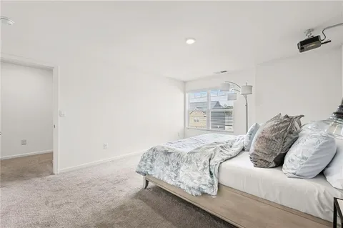 a bedroom with a bed and a wall painting