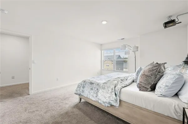 a bedroom with a bed and a wall painting