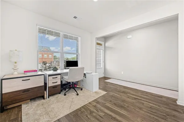 a living room with furniture and wooden floor
