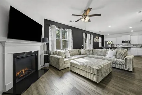 a living room with furniture fireplace and flat screen tv