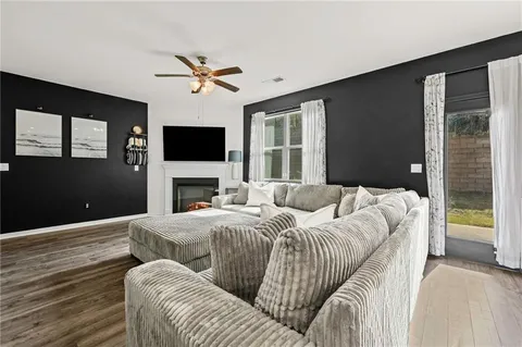 a living room with a couch a fireplace and a flat screen tv