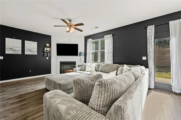 a living room with a couch a fireplace and a flat screen tv