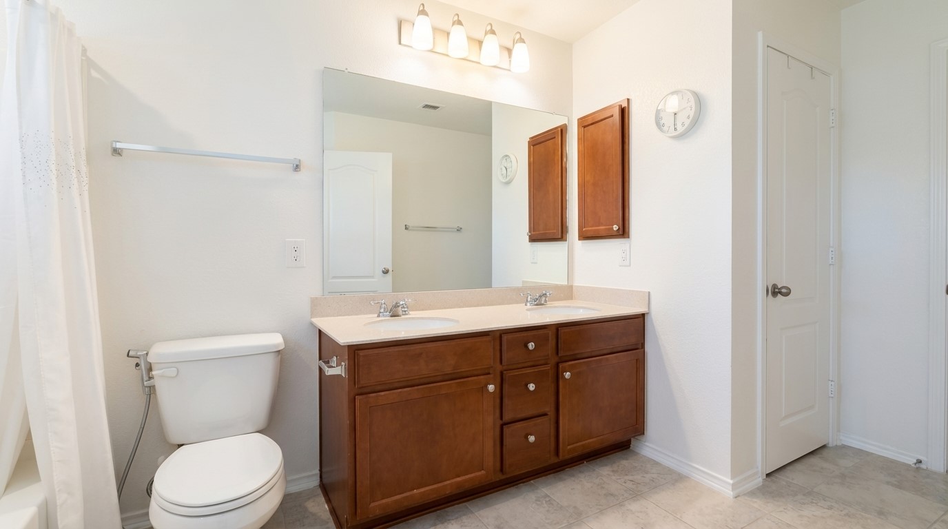 308 Los Cobos Lane Georgetown, TX 78626 - Photo 20 of 31 a bathroom with a toilet a sink and mirror