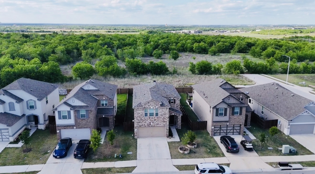 308 Los Cobos Lane Georgetown, TX 78626 - Photo 2 of 31 an aerial view of multiple houses with a yard