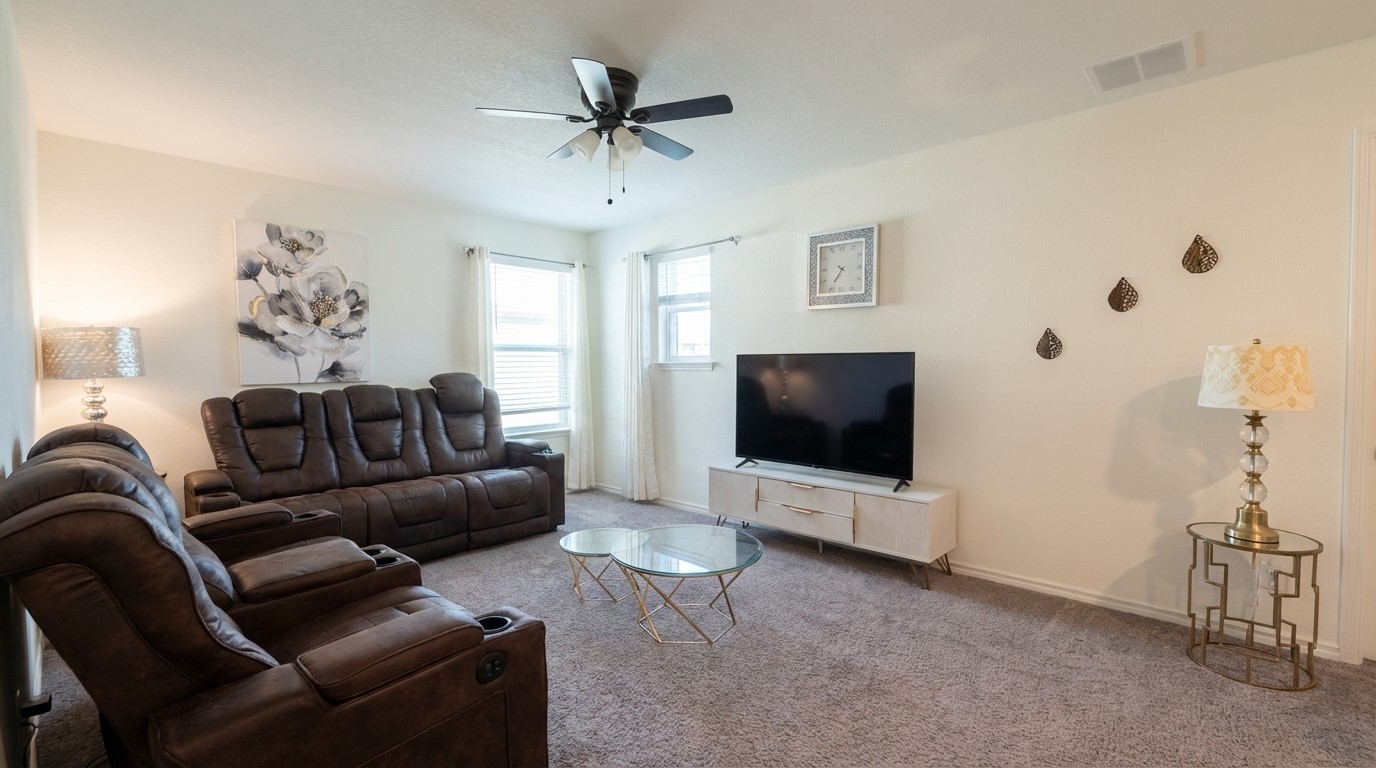 308 Los Cobos Lane Georgetown, TX 78626 - Photo 25 of 31 a living room with furniture and a flat screen tv
