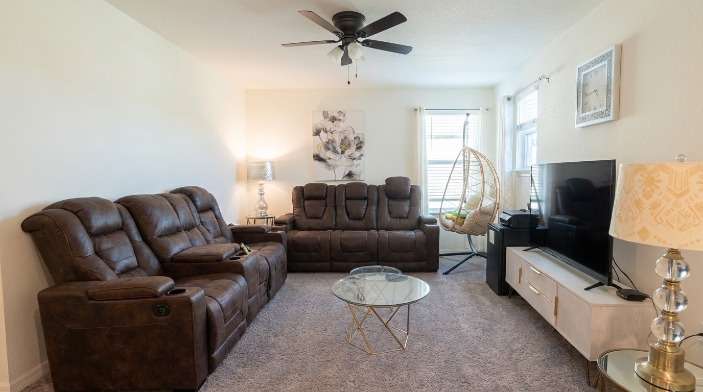 308 Los Cobos Lane Georgetown, TX 78626 - Photo 26 of 31 a living room with furniture a fireplace and a chandelier