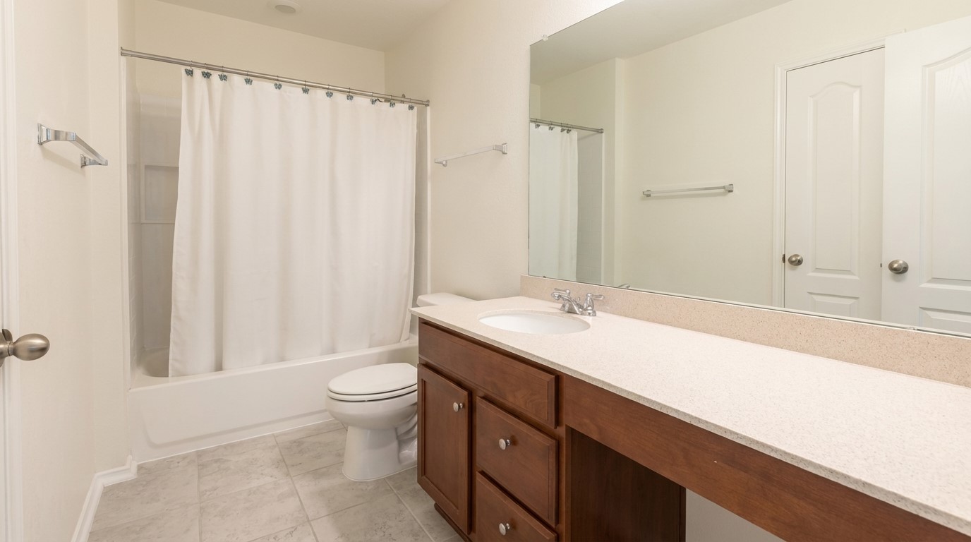 308 Los Cobos Lane Georgetown, TX 78626 - Photo 27 of 31 a bathroom with a double vanity sink toilet and a mirror