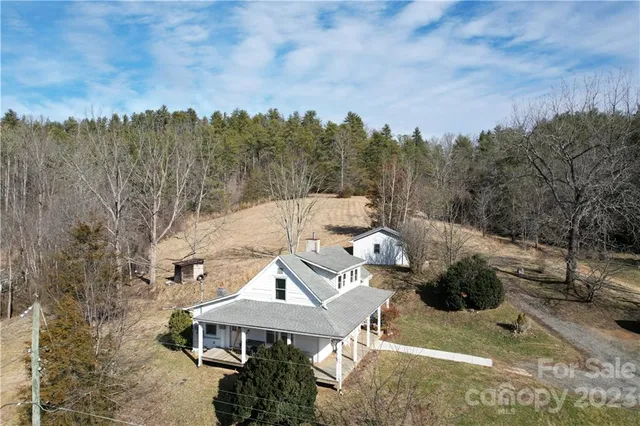 a view of a house with a yard and sitting area