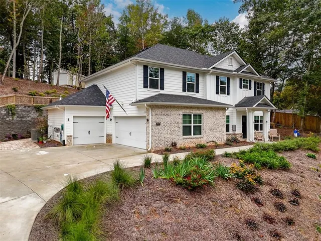 a front view of a house with a garden and porch