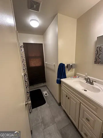 a bathroom with double sink and mirror