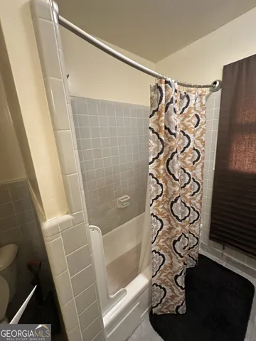 a bathroom with a shower and a window
