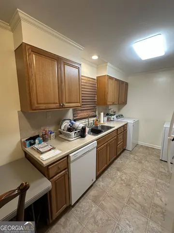 a kitchen with a sink cabinets and window