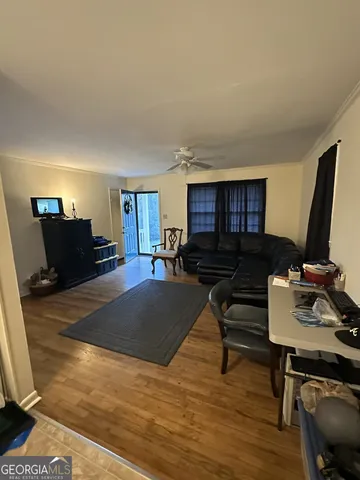 a living room with furniture and a flat screen tv