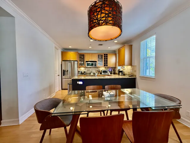 a kitchen with a dining table and chairs