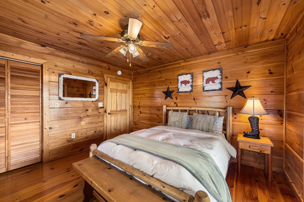 890 Brittney Drive Blue Ridge, GA 30513 - Photo 24 of 37 a bedroom with a bed and wooden floor