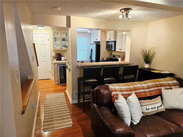 a kitchen with stainless steel appliances kitchen island granite countertop furniture and a refrigerator