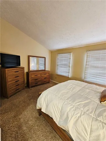 a bedroom with a bed and dresser