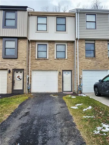 a view of a house with a yard and garage