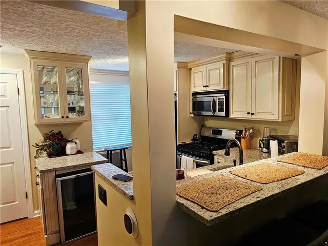 a kitchen with a stove a sink and a microwave