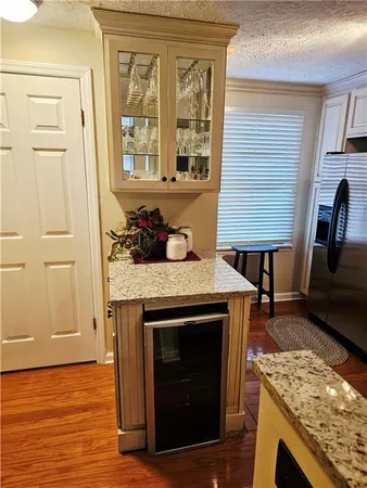 a kitchen with granite countertop wooden floor and a fireplace