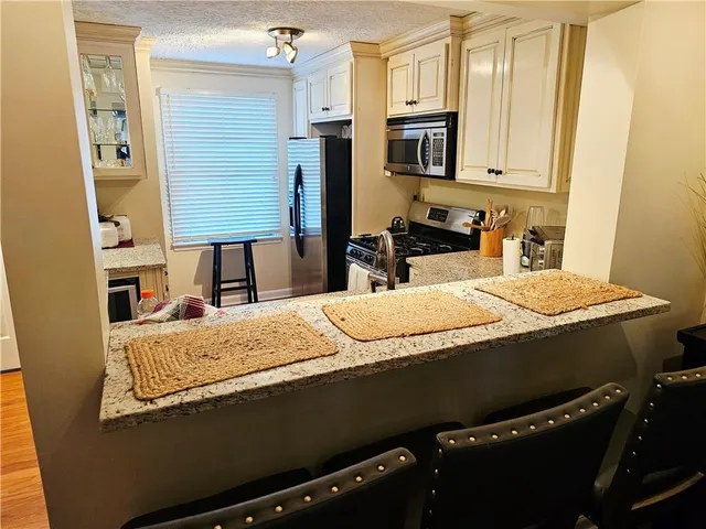 a room with a bed and a television