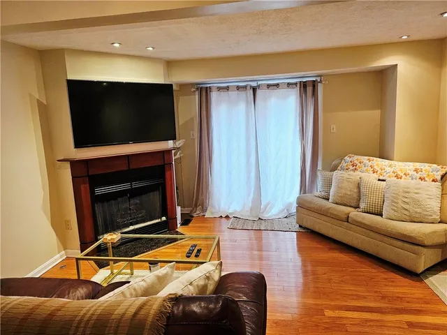 a living room with furniture flat screen tv and a fireplace