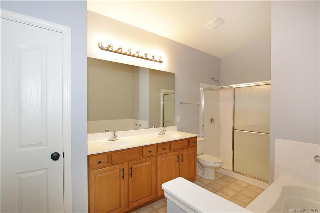 16646 Amberside Road East Cornelius, NC 28031 - Photo 14 of 29 a bathroom with a sink a toilet and a mirror