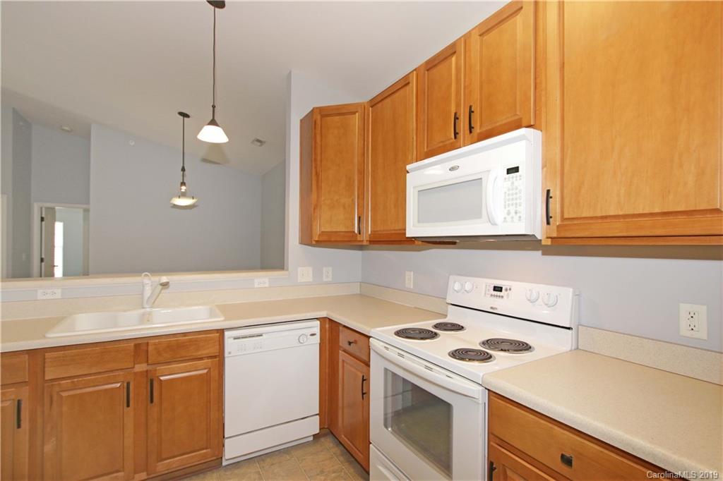 16646 Amberside Road East Cornelius, NC 28031 - Photo 8 of 29 a kitchen with a sink a stove and cabinets
