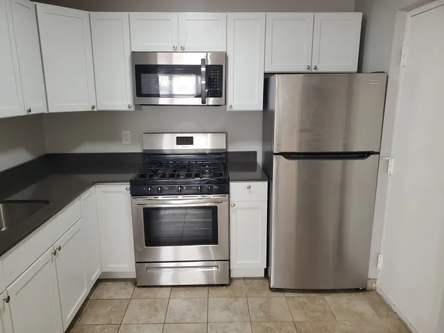 a kitchen with appliances and cabinets
