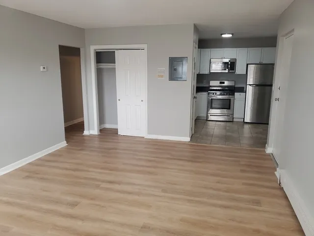 a view of kitchen view wooden floor and electronic appliances