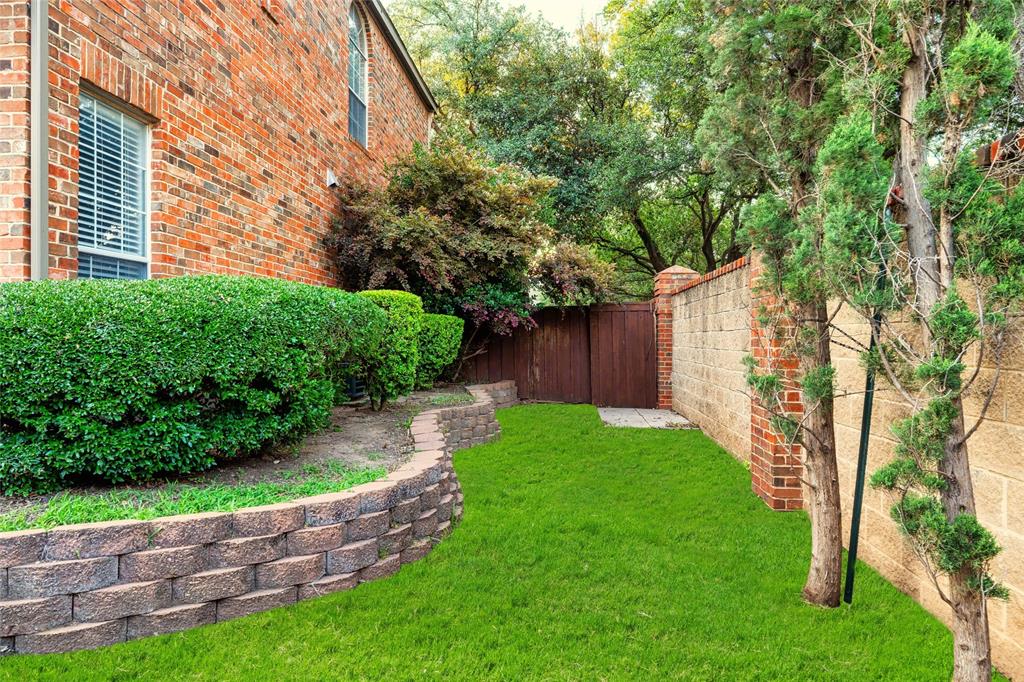 4160 Towne Green Circle Addison, TX 75001 - Photo 20 of 24 View of corner yard, rare to have this much grass and a backyard on a townhome!