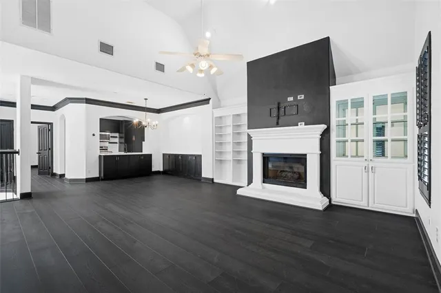 a view of a room with wooden floors and fireplace