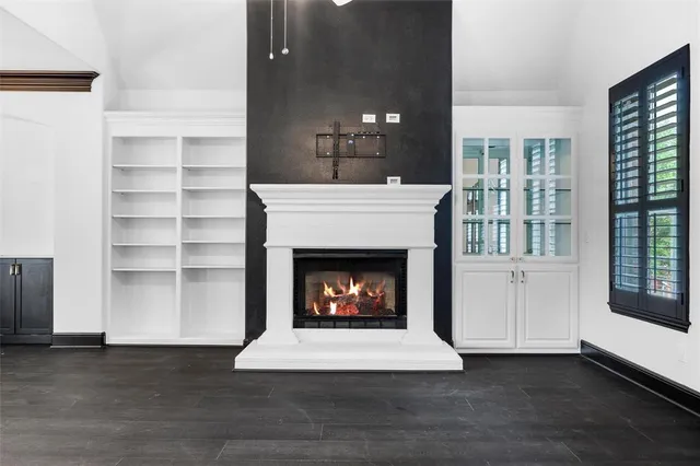 a living room with a fireplace and a large window