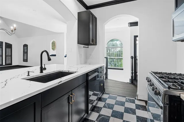 a kitchen with a sink a stove and a window