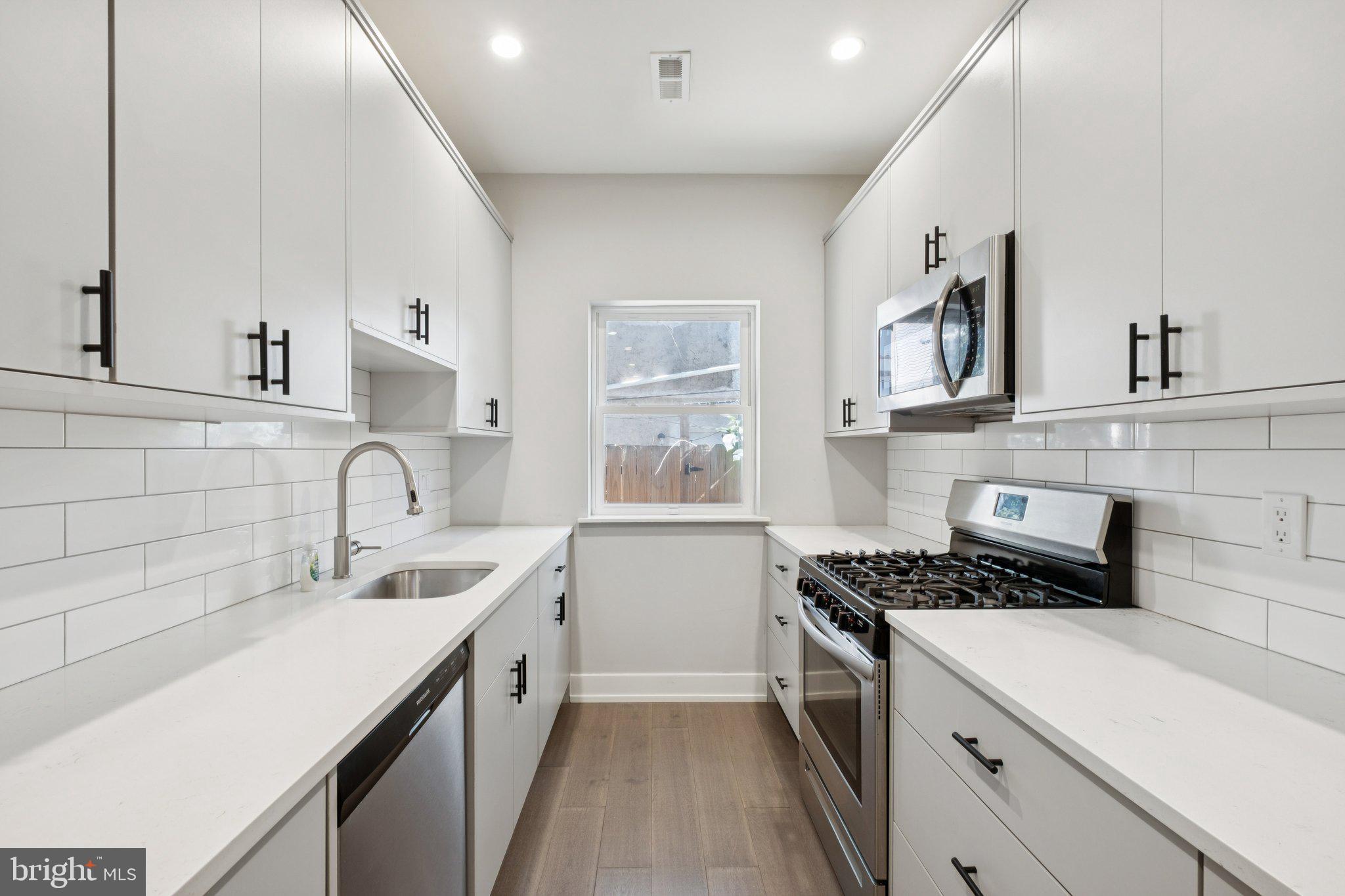 1533 South Lambert Street Philadelphia, PA 19146 - Photo 14 of 29 a kitchen with a sink stove top oven and cabinets