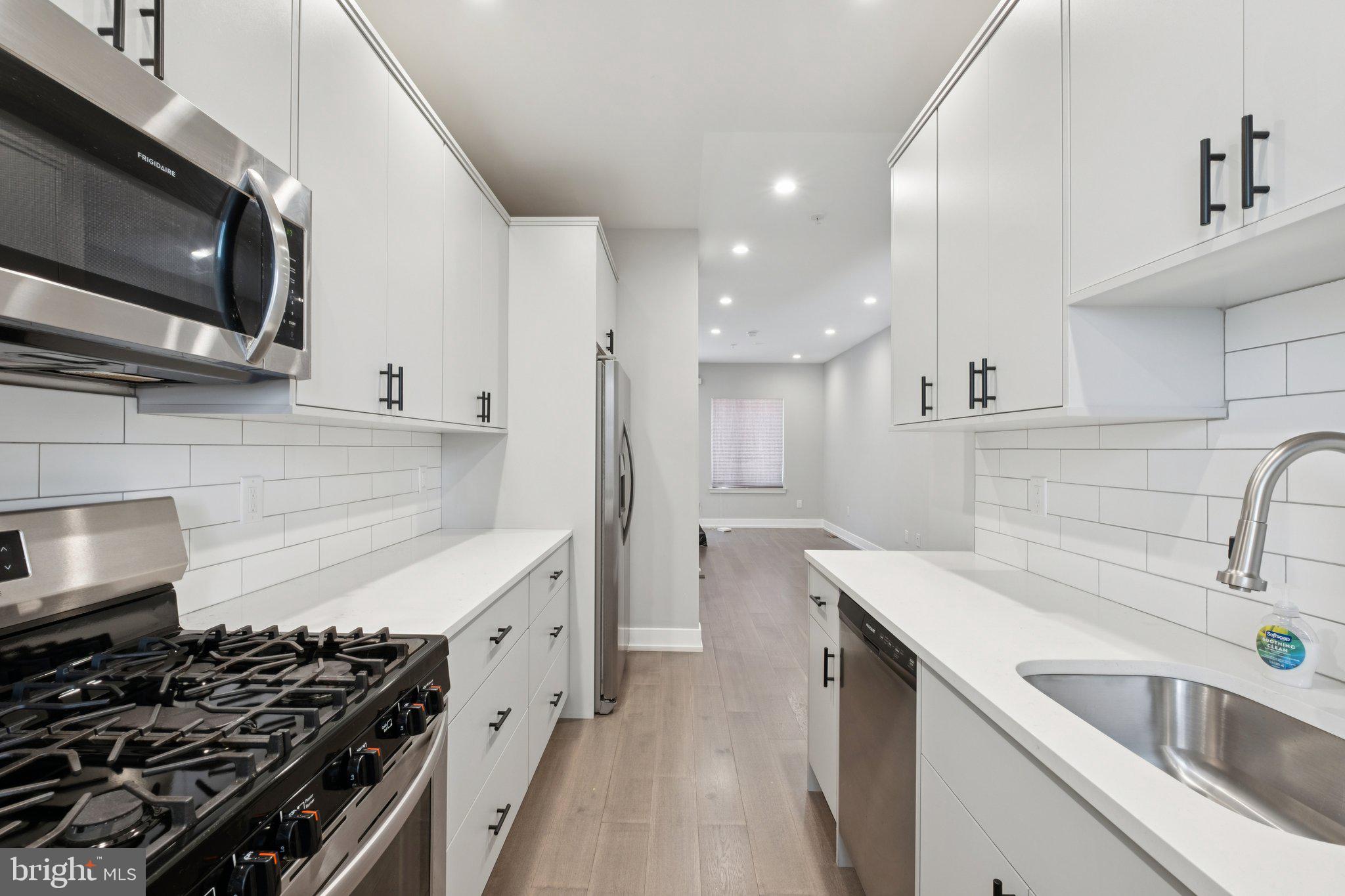 1533 South Lambert Street Philadelphia, PA 19146 - Photo 15 of 29 a kitchen with stainless steel appliances a sink a stove and microwave