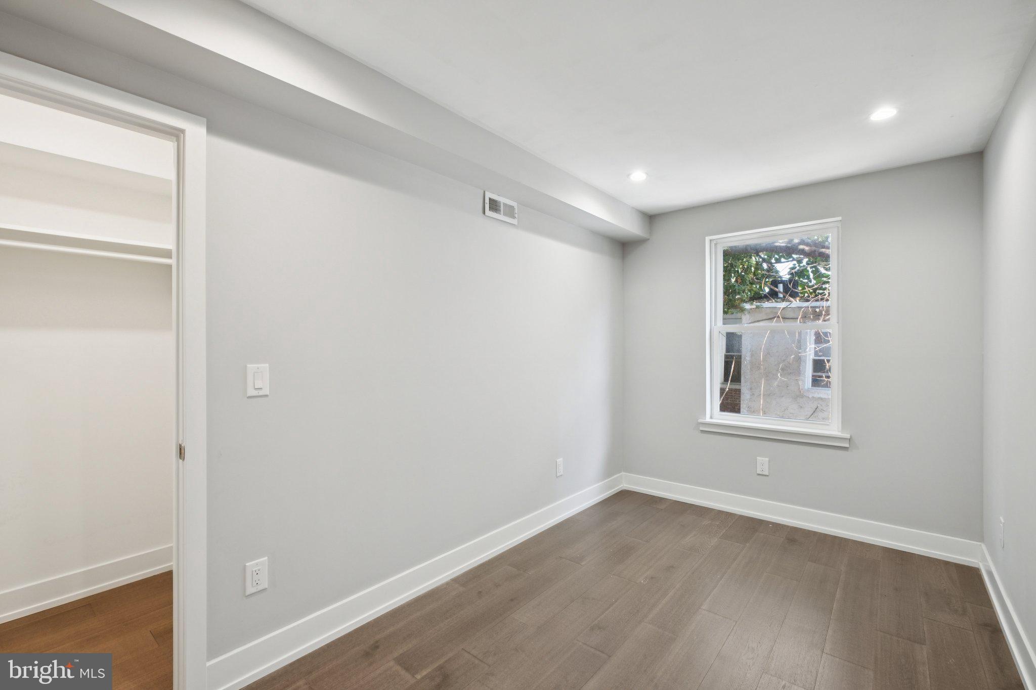 1533 South Lambert Street Philadelphia, PA 19146 - Photo 16 of 29 a view of an empty room with wooden floor and a window