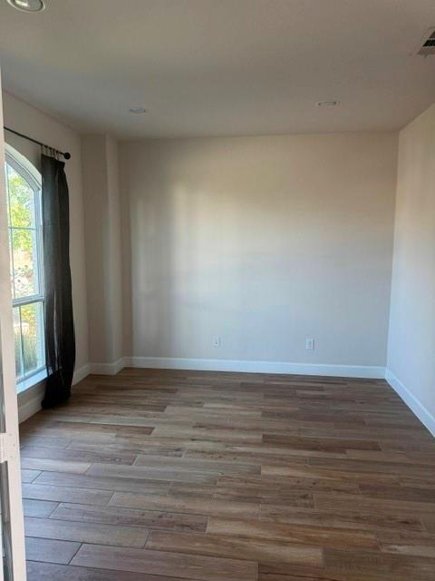 1917 Halkin Road Celina, TX 75009 - Photo 8 of 24 a view of an empty room with wooden floor and a window